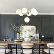 Load image into Gallery viewer, Mid-Century 7-light Brass Opal Glass Globe Sputnik Chandelier